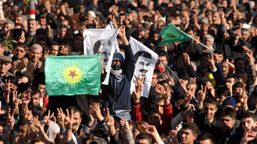A boy waves a flag of jailed PKK leader Abdullah Ocalan as tens of thousands of Kurds gather during a rally of the DTP.