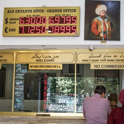 People exchange money at a currency exchange office on Aug. 13, 2018, in Istanbul, Turkey. 