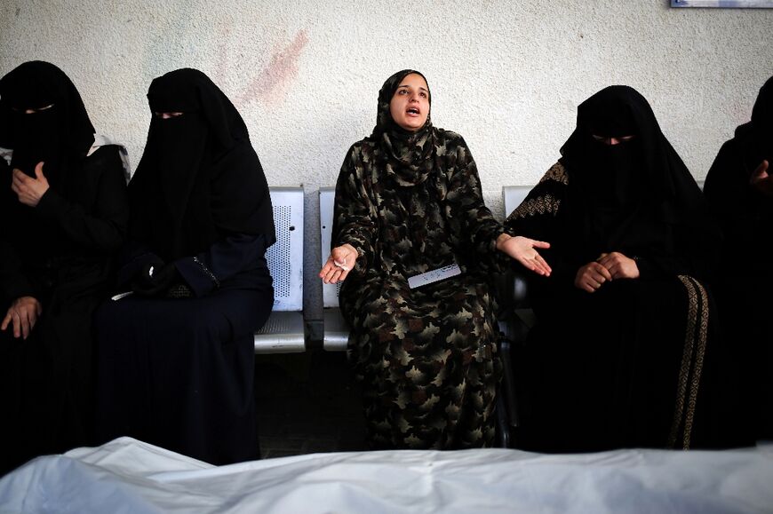 Sanaa Zoorob, centre, mourns at Al-Najjar Hospital, Rafah, her sister and the sister's six children killed in a strike on their home
